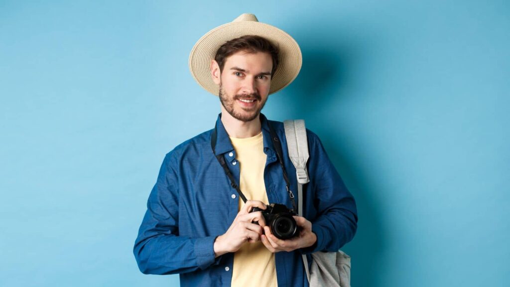 Man going on a vacation and holidng a camera