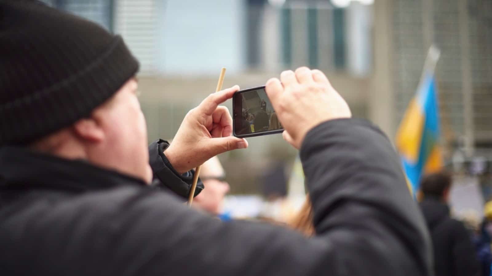 Man taking photo of people on the street