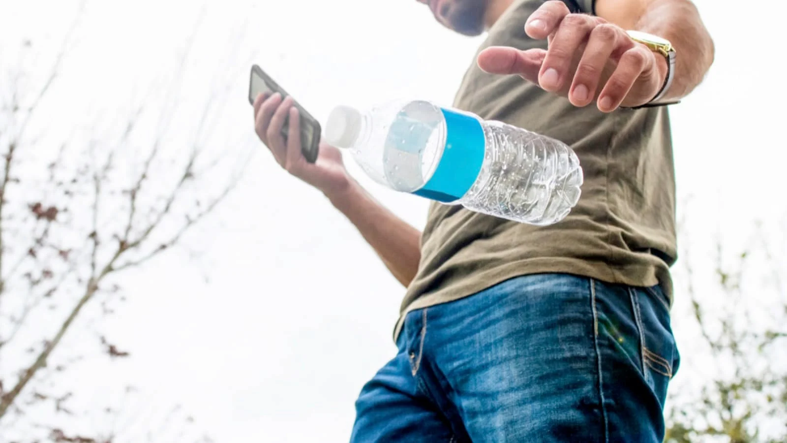 Man throwing plastic bottle