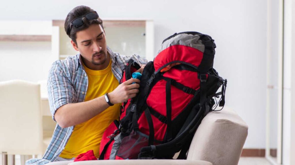 Backpacker packing for his trip