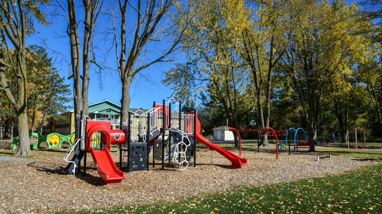 Large set of children's games in a park near a school