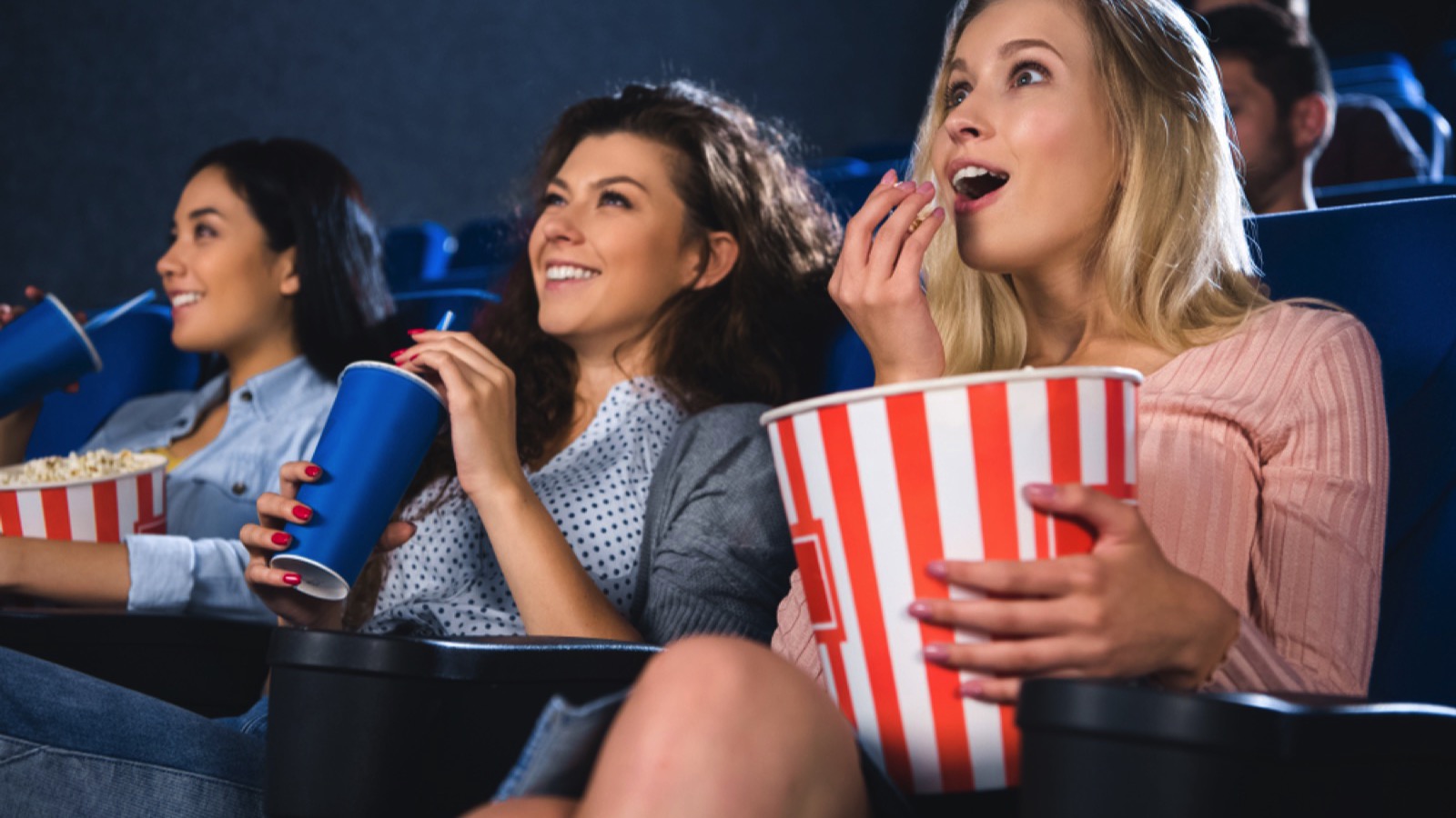 Friends enjoying movie in theatre