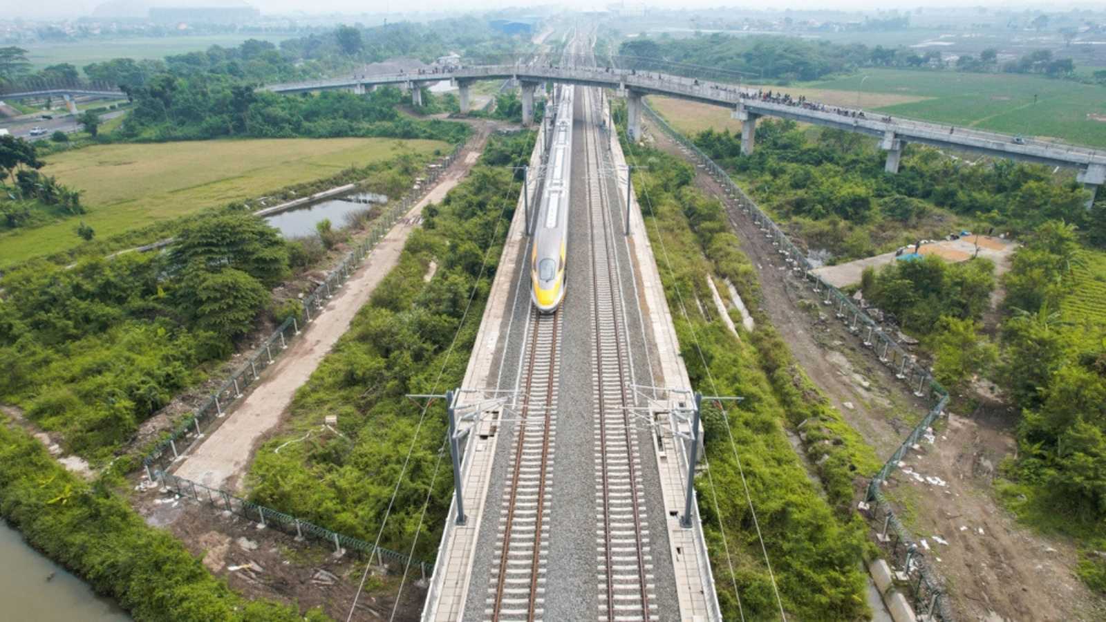 Aerial view of the High speed orange train on the railway station. High Speed Train Jakarta-Bandung. Bandung, Indonesia, November 22, 2022