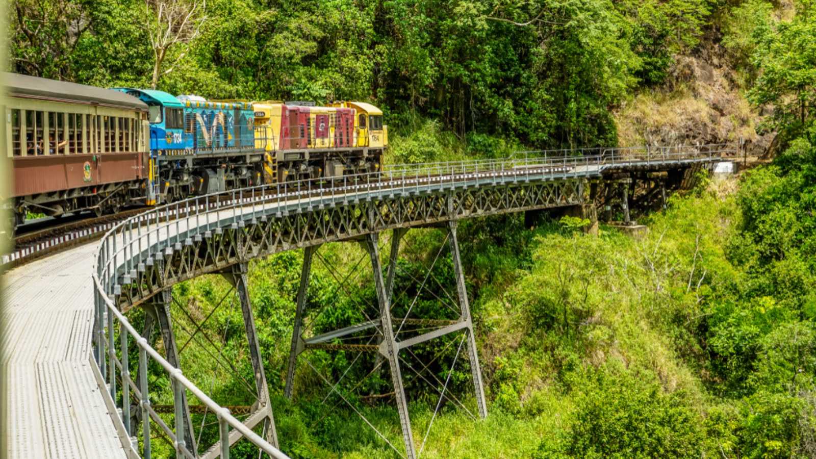 KURANDA, QUEENSLAND, AUSTRALIA - DECEMBER 21, 2017: Kuranda Scenic Railway crossing an elevated bridge over Barron Gorge National Park on its way to Kuranda.