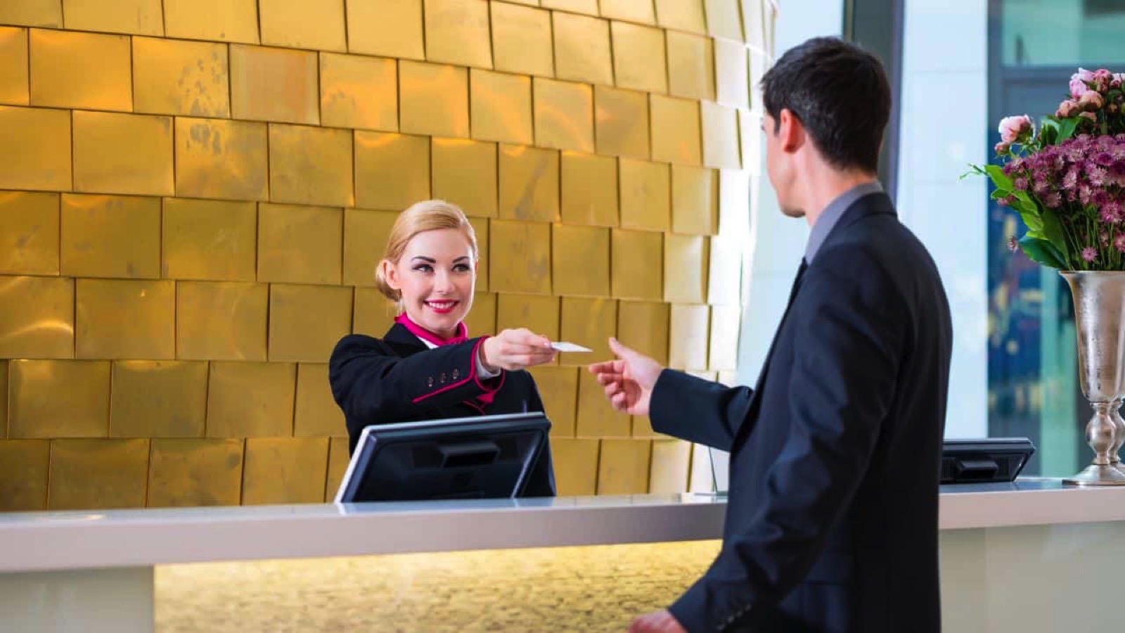 Man getting key card from receptionist