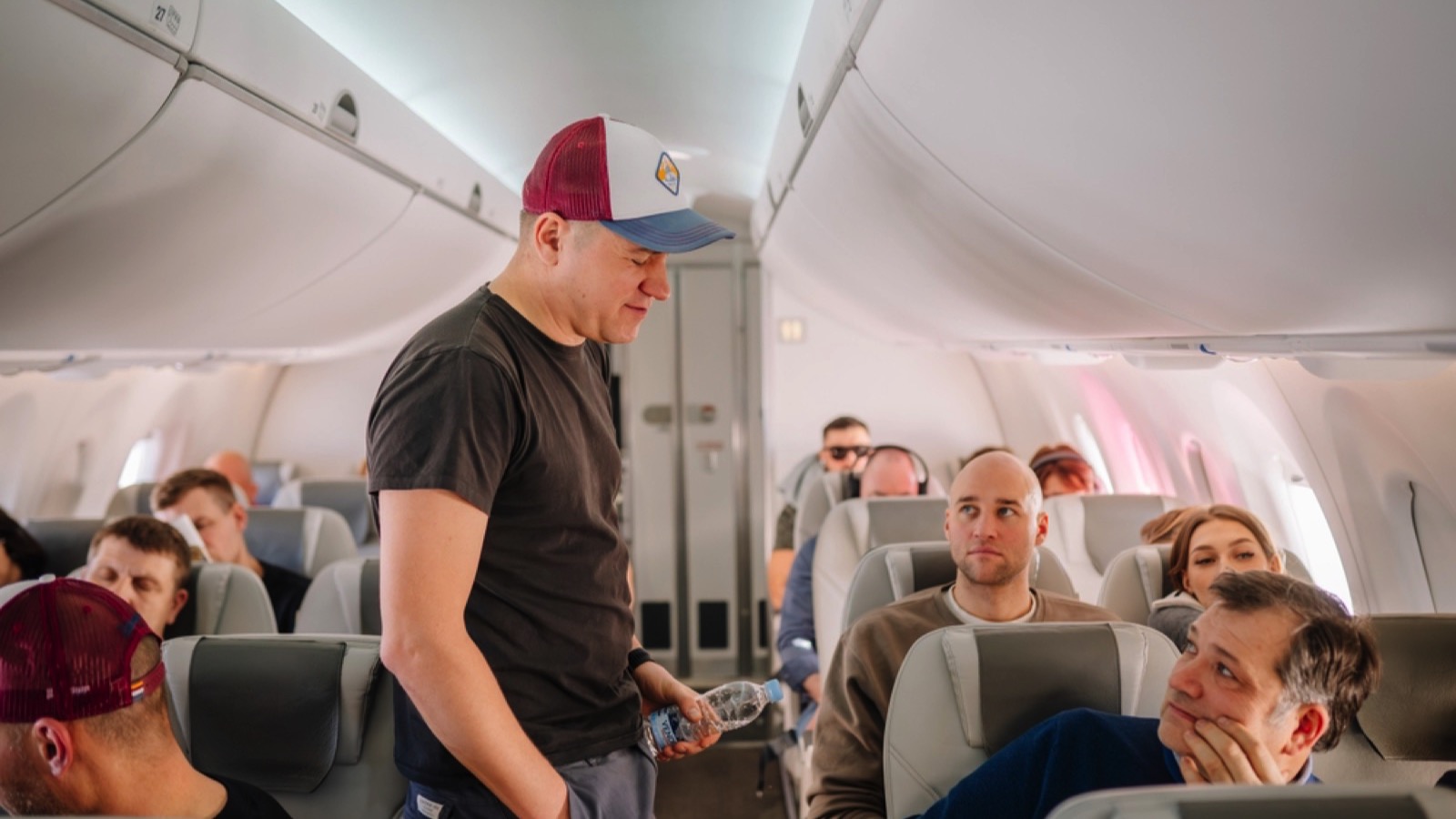 Man walking in aisle of flight