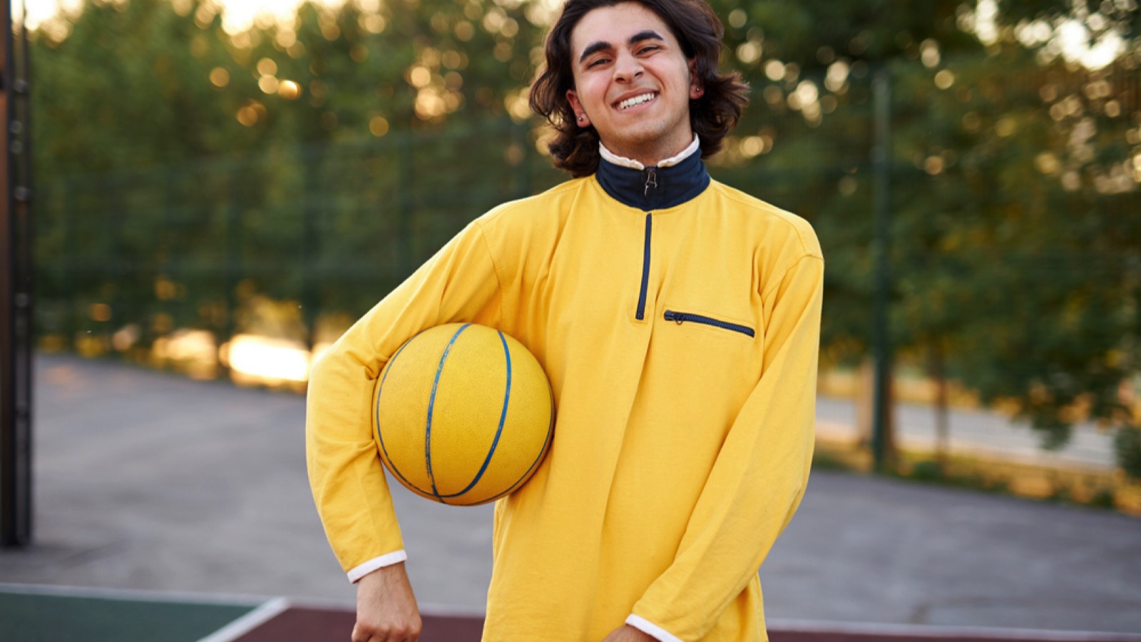 Teen boy playing basketball