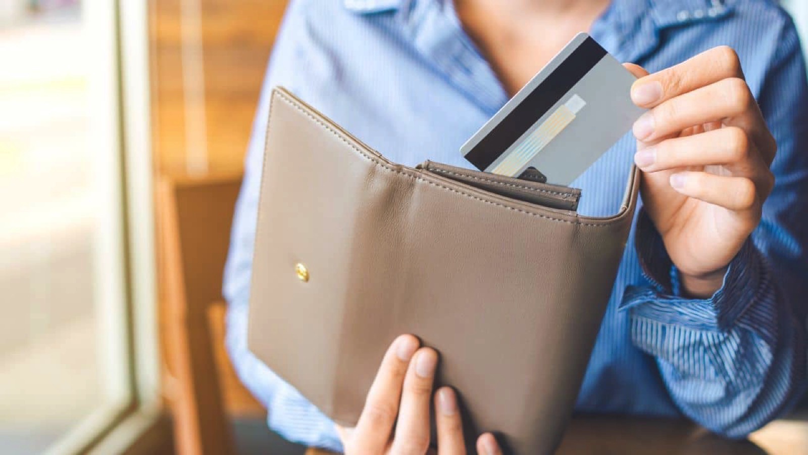 Woman taking credit card from wallet