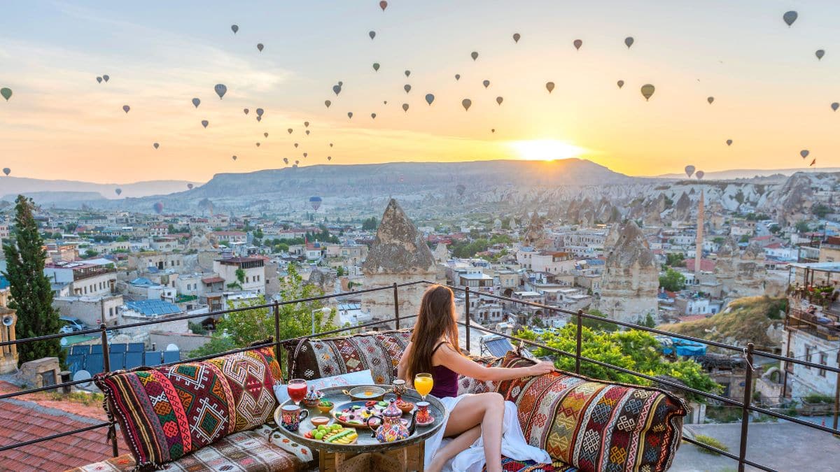 woman looking at hot air balloons in Cappadocia Turkey