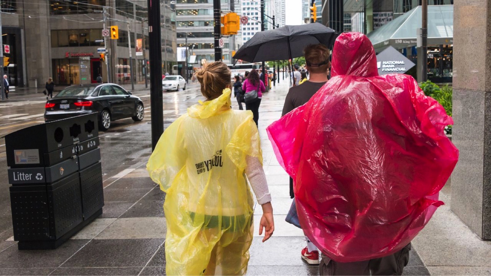 Toronto, Canada - 26 June 2017: Crowd of people with umbrellas and rain ponchos on a rainy day