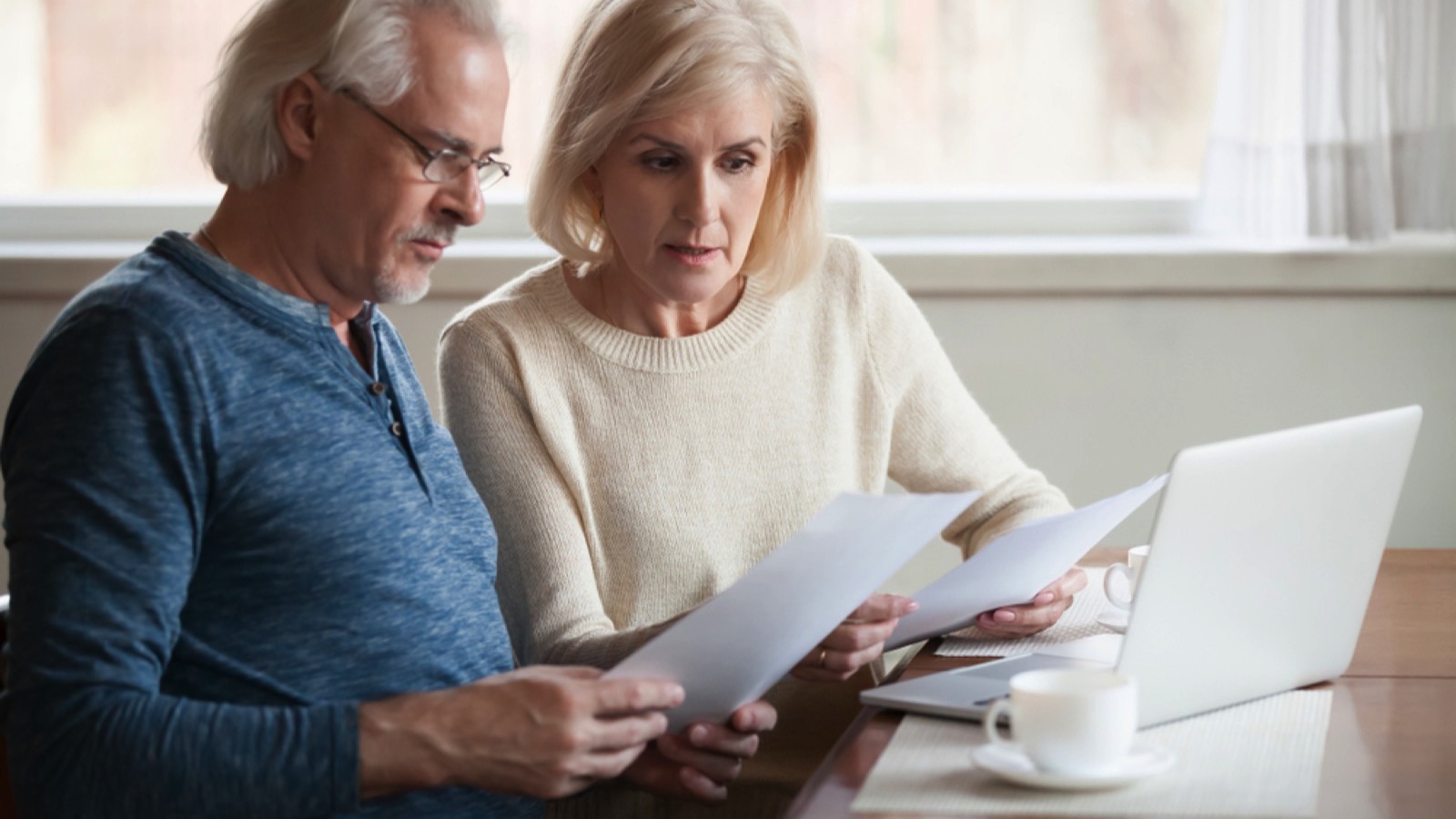 Boomer couples discussing bills