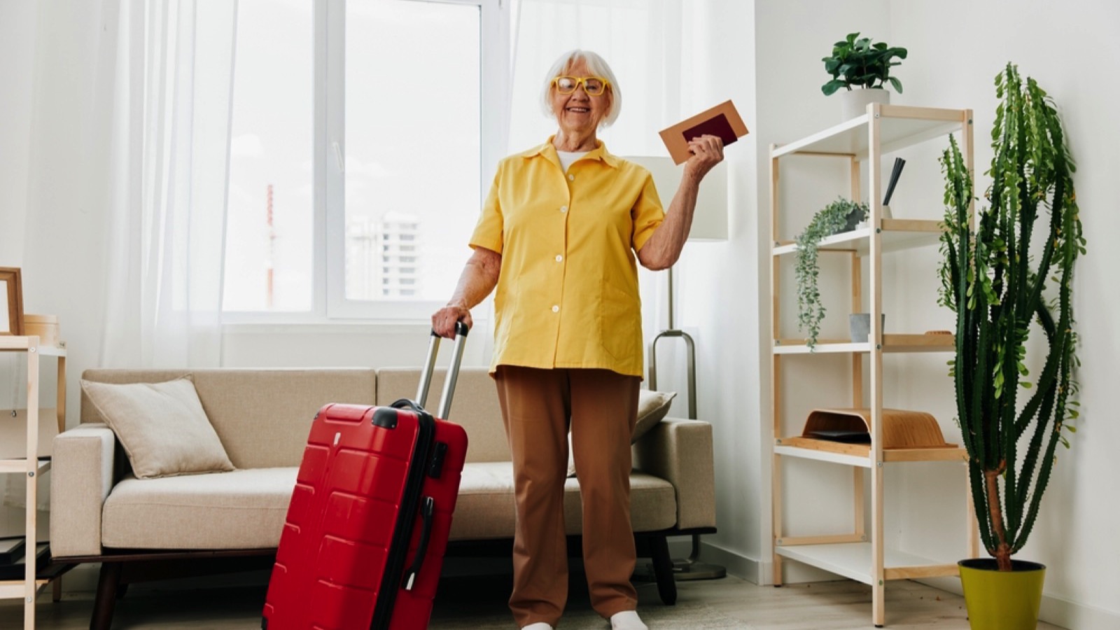 Happy senior woman packing for travel