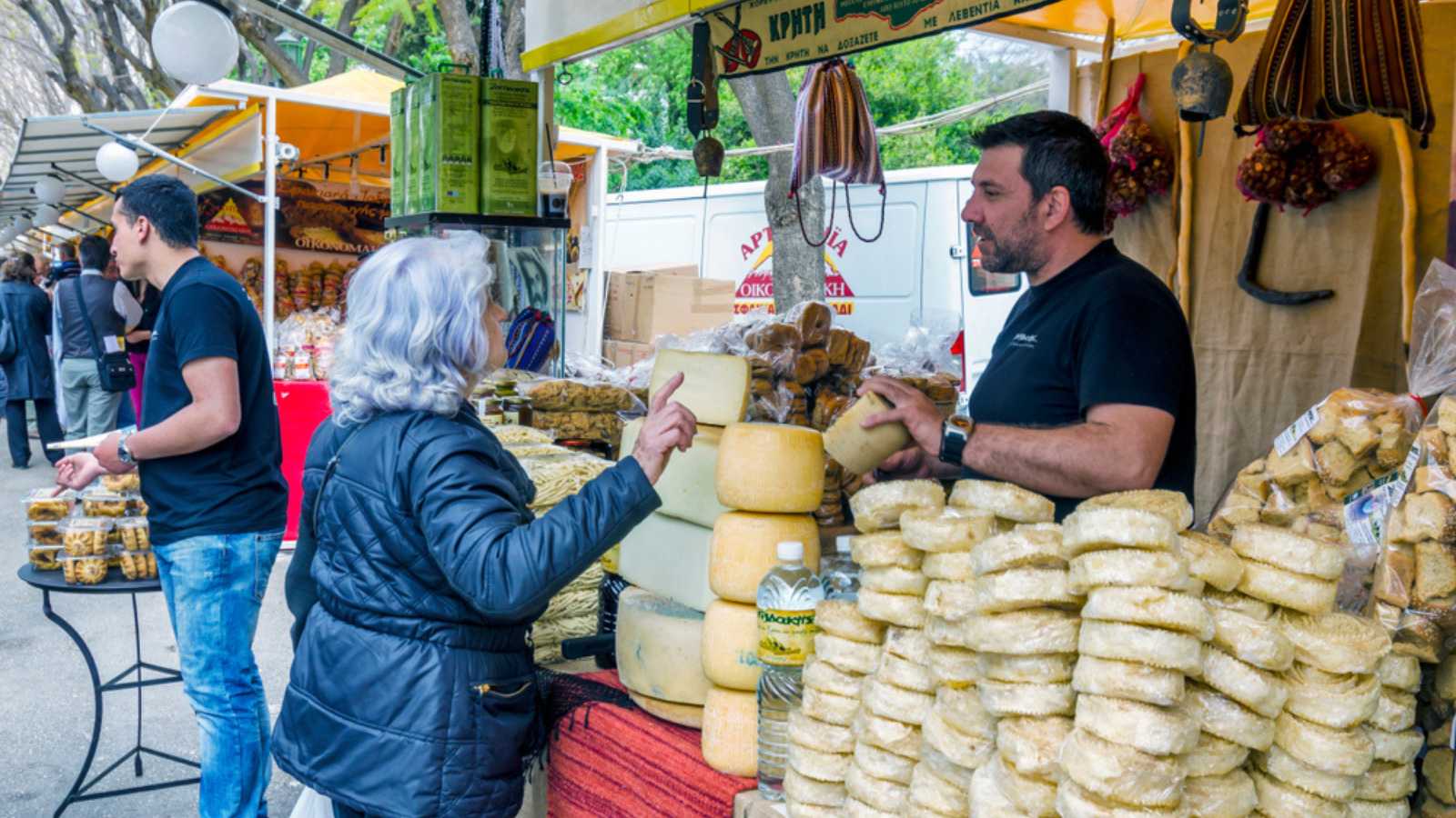 Athens, Attica / Greece - April 20, 2013: Exhibition of Cretan products in Zappeion. People selling and buying traditional cretan products like olive oil, cheese products, wine, honey, olives etc.