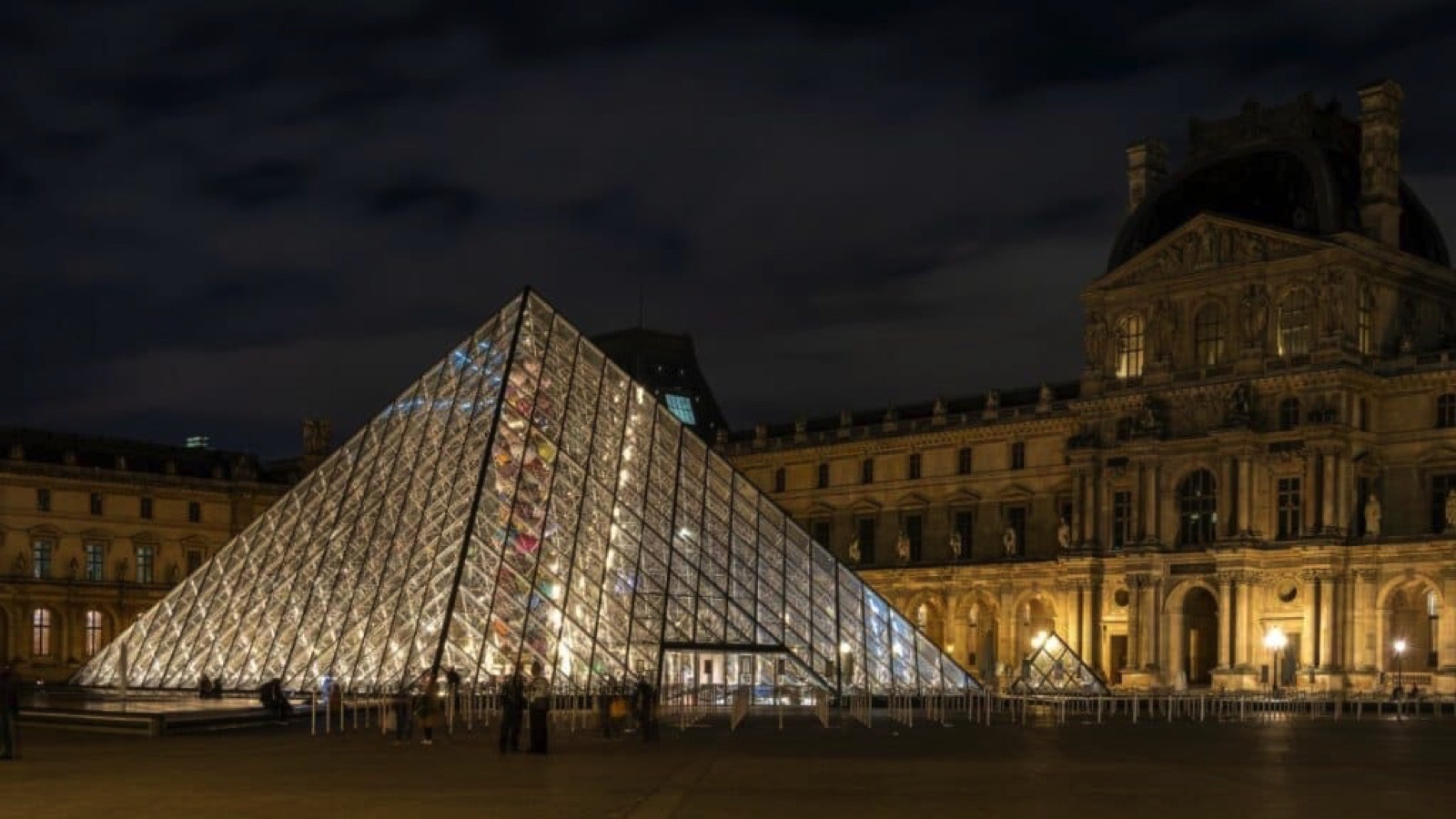 Paris, France - Sep 25 2022; The Louvre glass pyramid illuminated at night