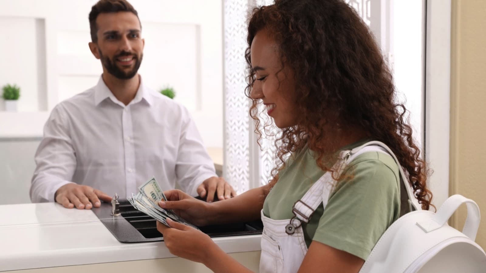 Man-depositing-money-in-bank