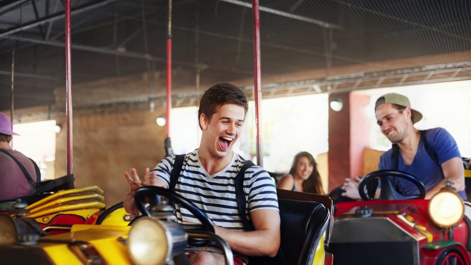 Man with friends enjoying in dashing car