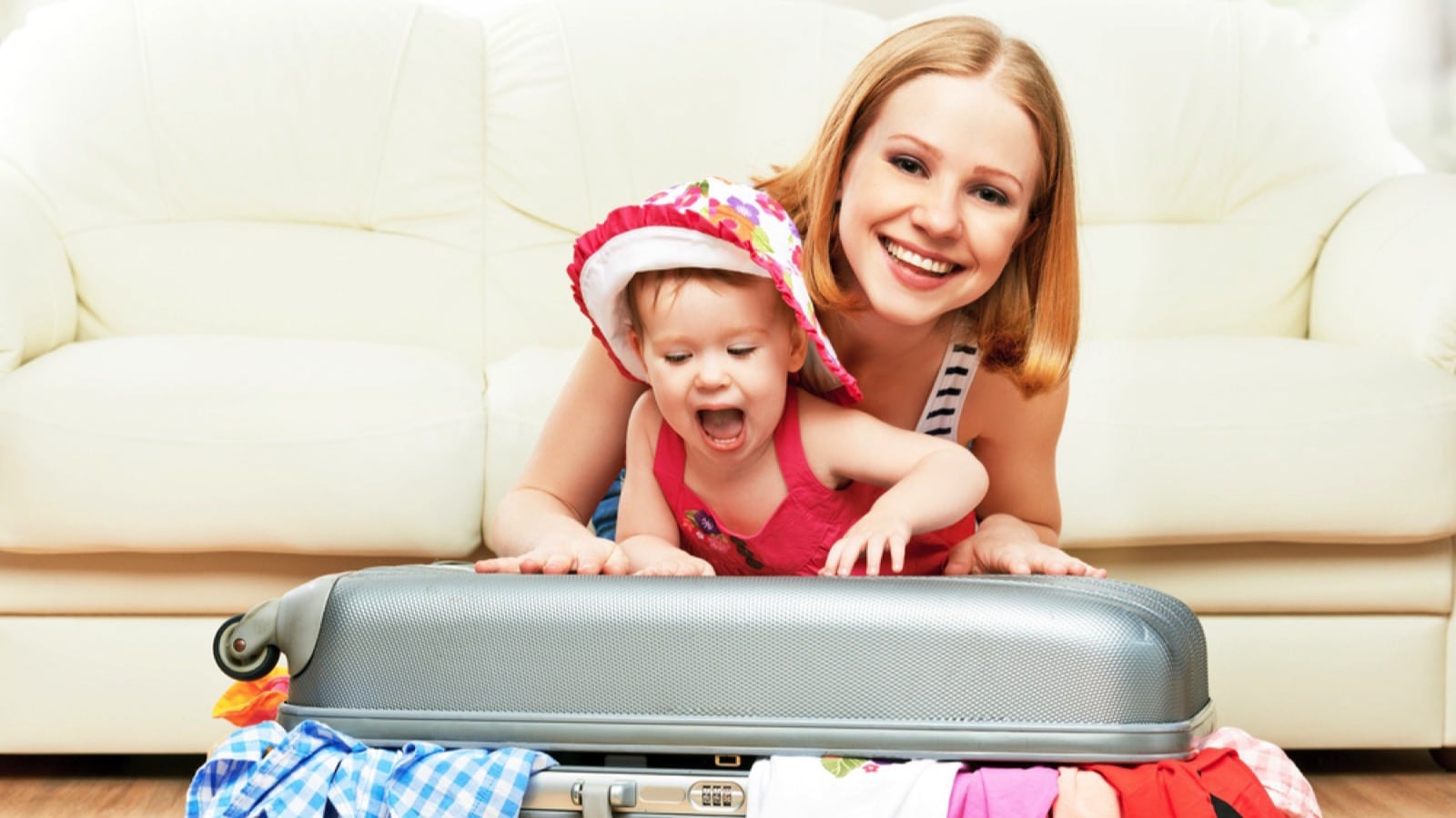 Mother packing suitcase with toddler