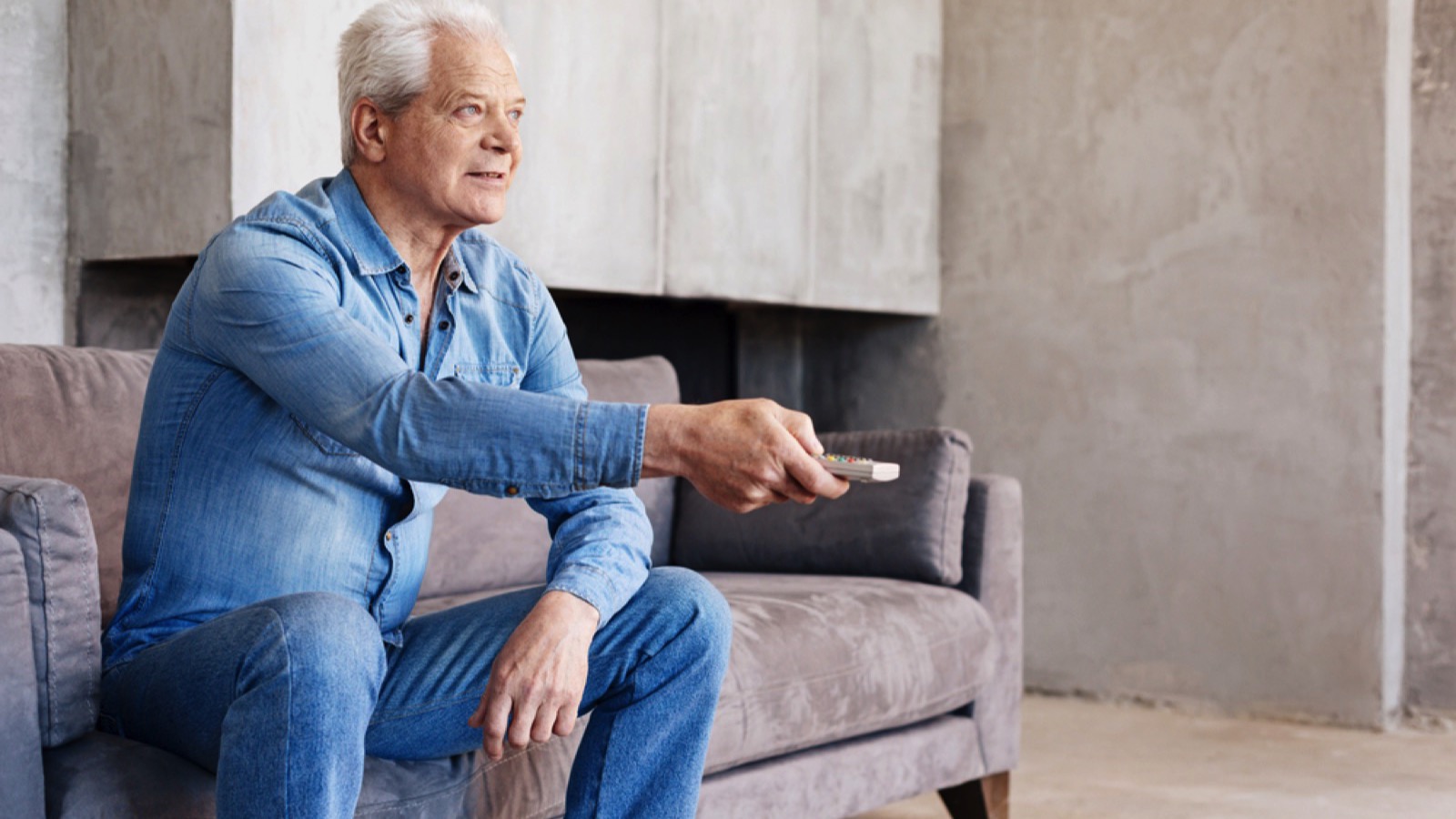 Old man operating smart tv