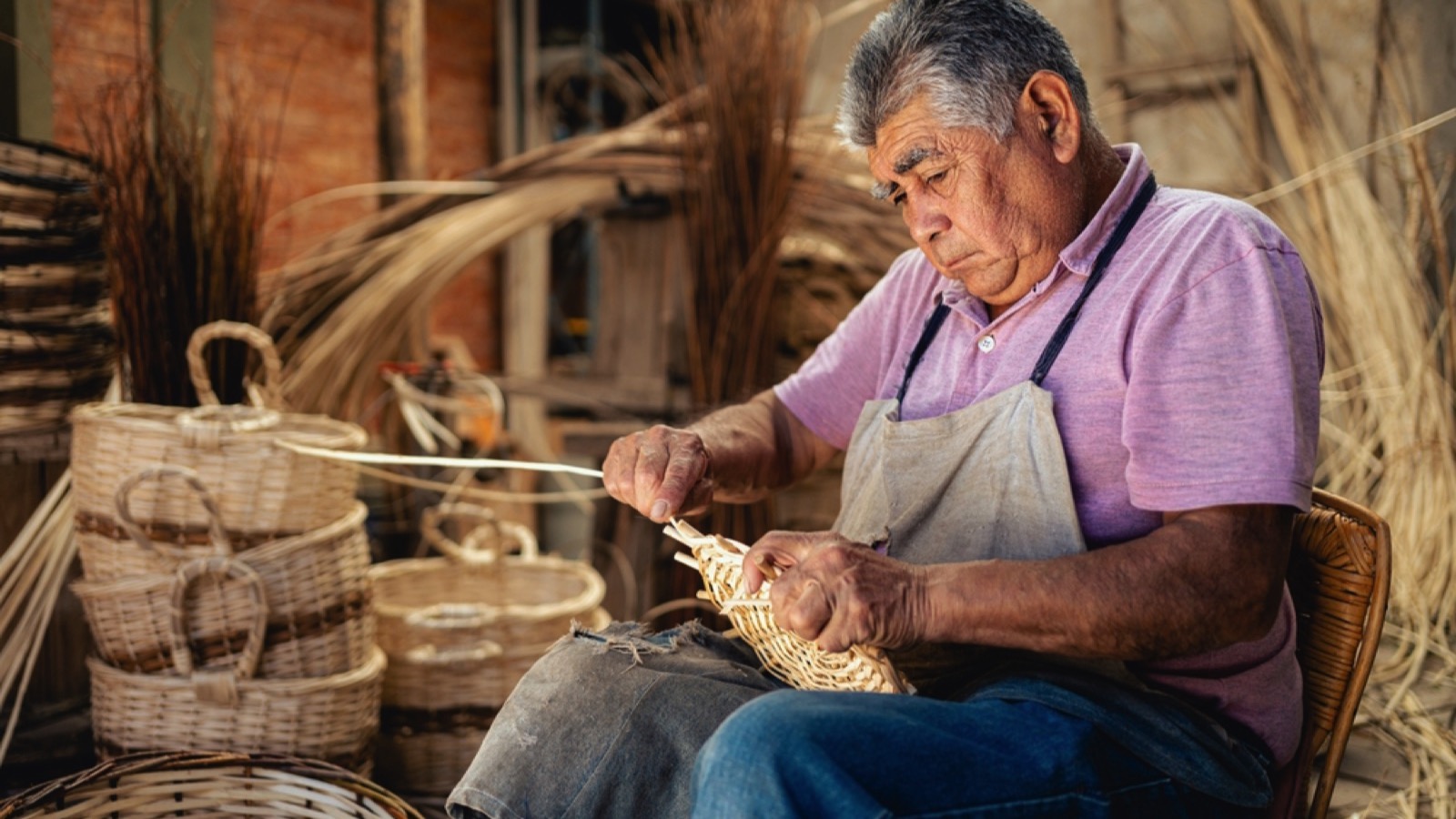 Old man weaving basket