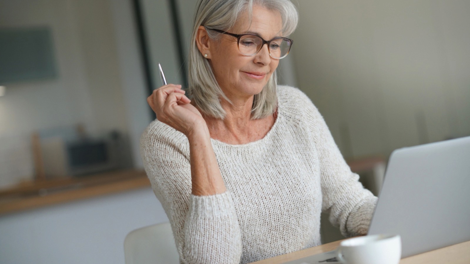 Old woman learning with laptop