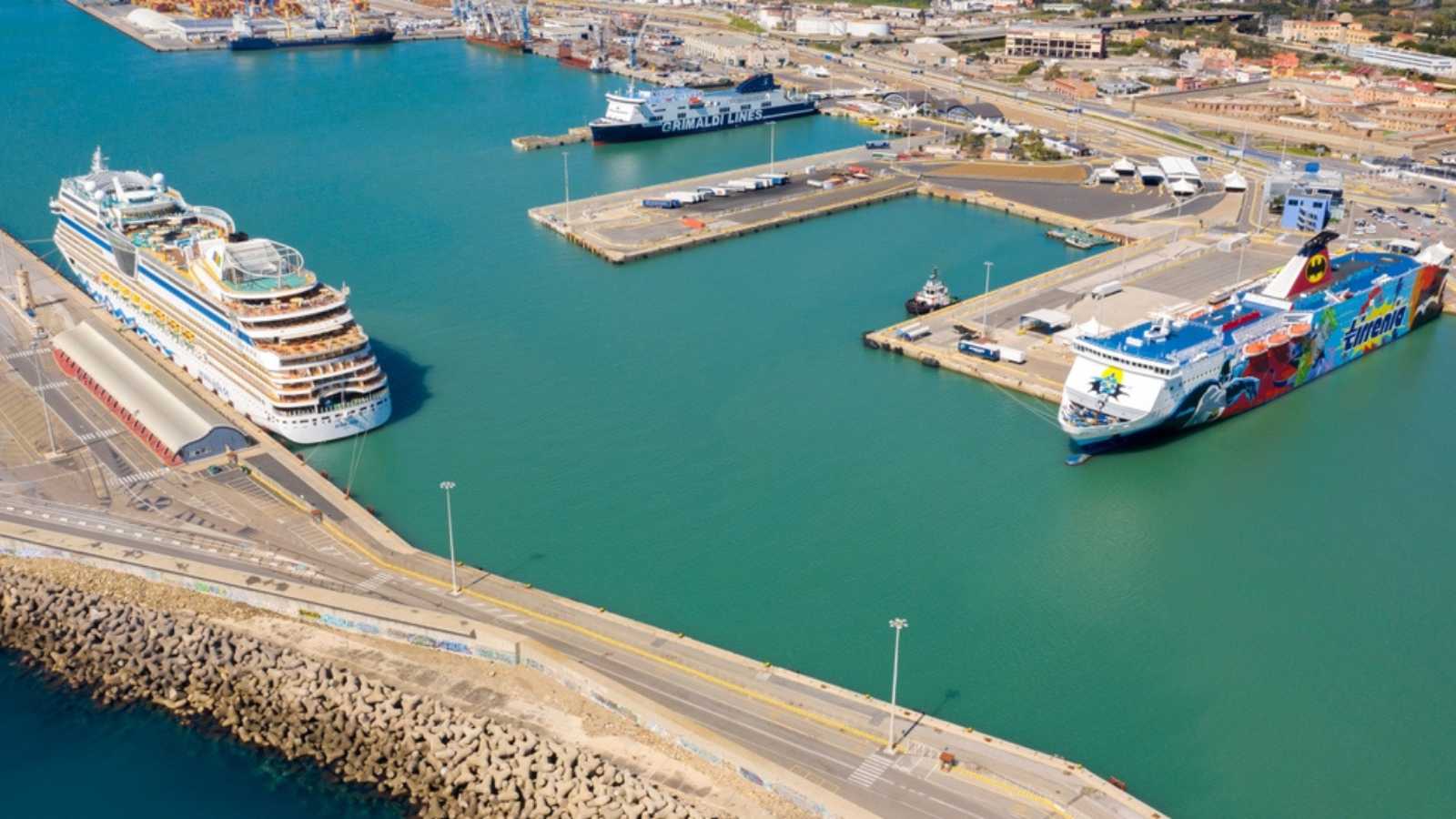 Civitavecchia, Italy - 03 30 2023: Aerial view on a Tirrenia ferry and a cruise ship docked at the port. There are other boats in the harbour.