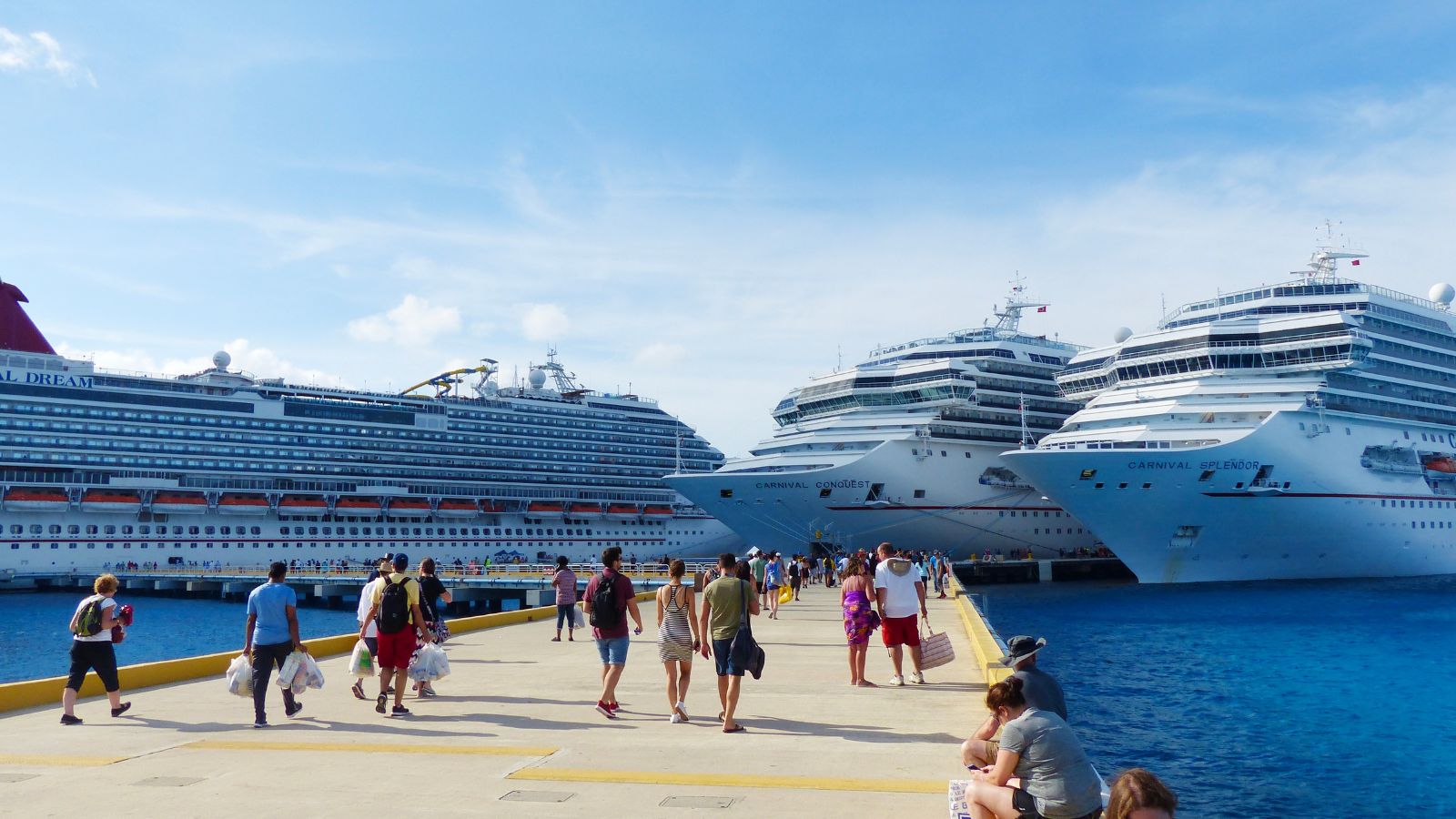 Cozumel, Mexico- November 2017: people walking on the pier with three cruise ships in the background