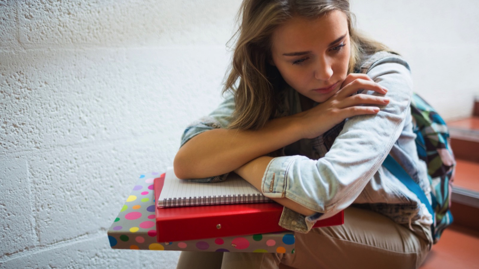 Sad student sitting on stairs