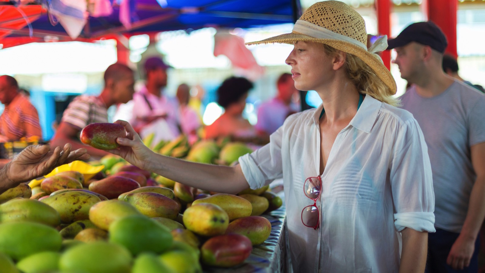 Tourist buying food in local market