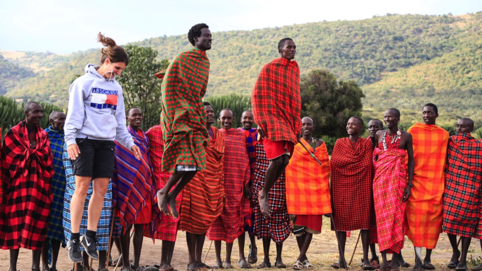 Tourist jumps with Masai warriors