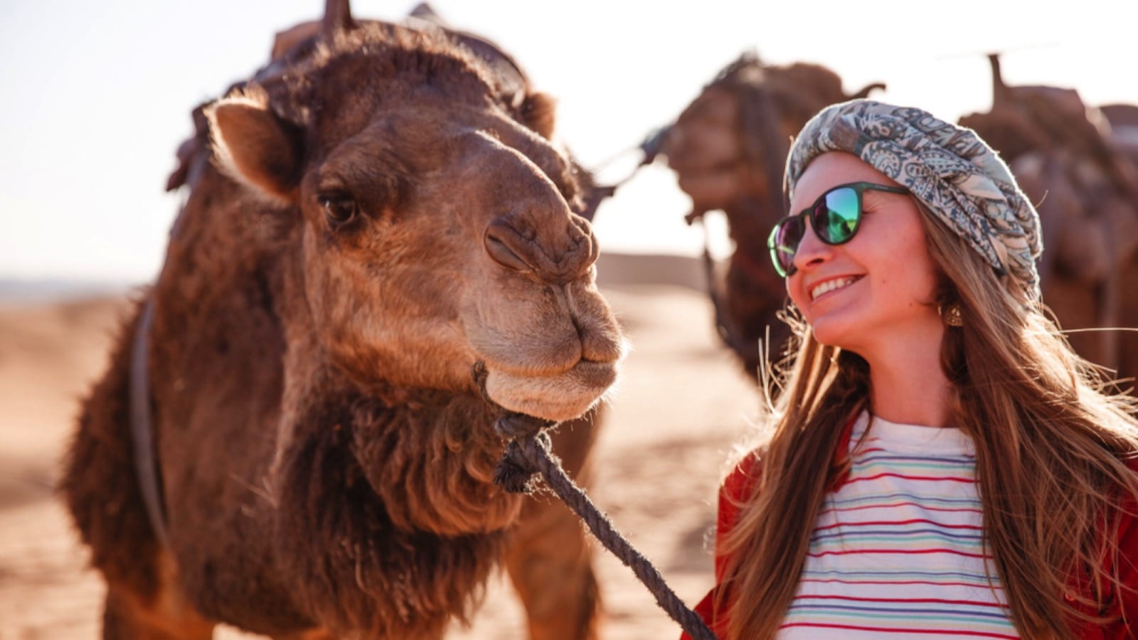 Woman-with-camel-in-Morocco-Sahara-Desert