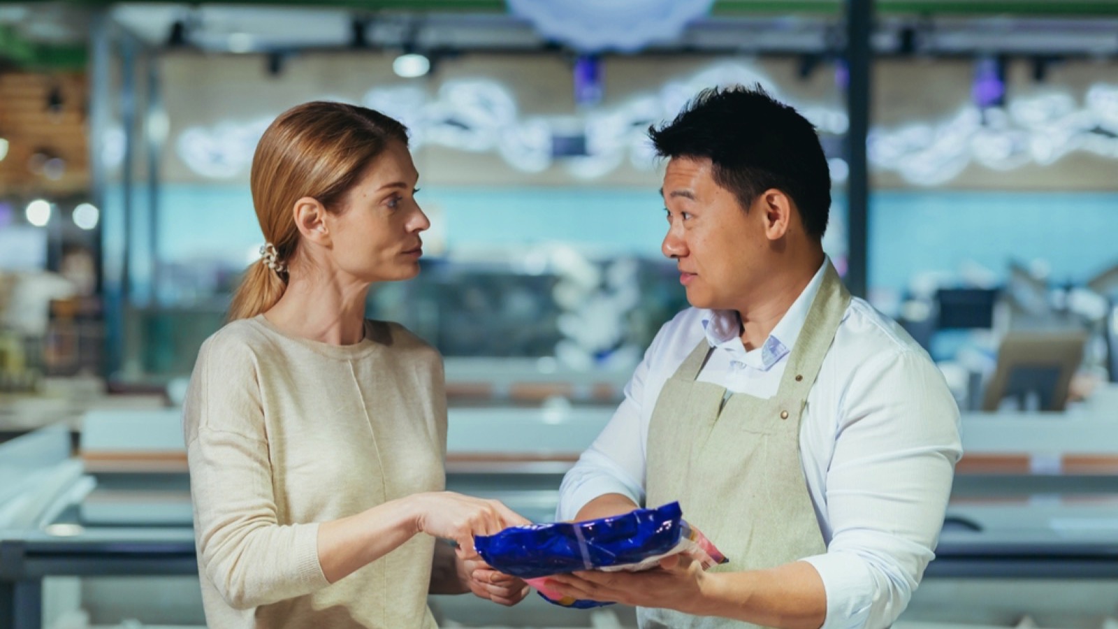 Young woman consults with a supermarket employee