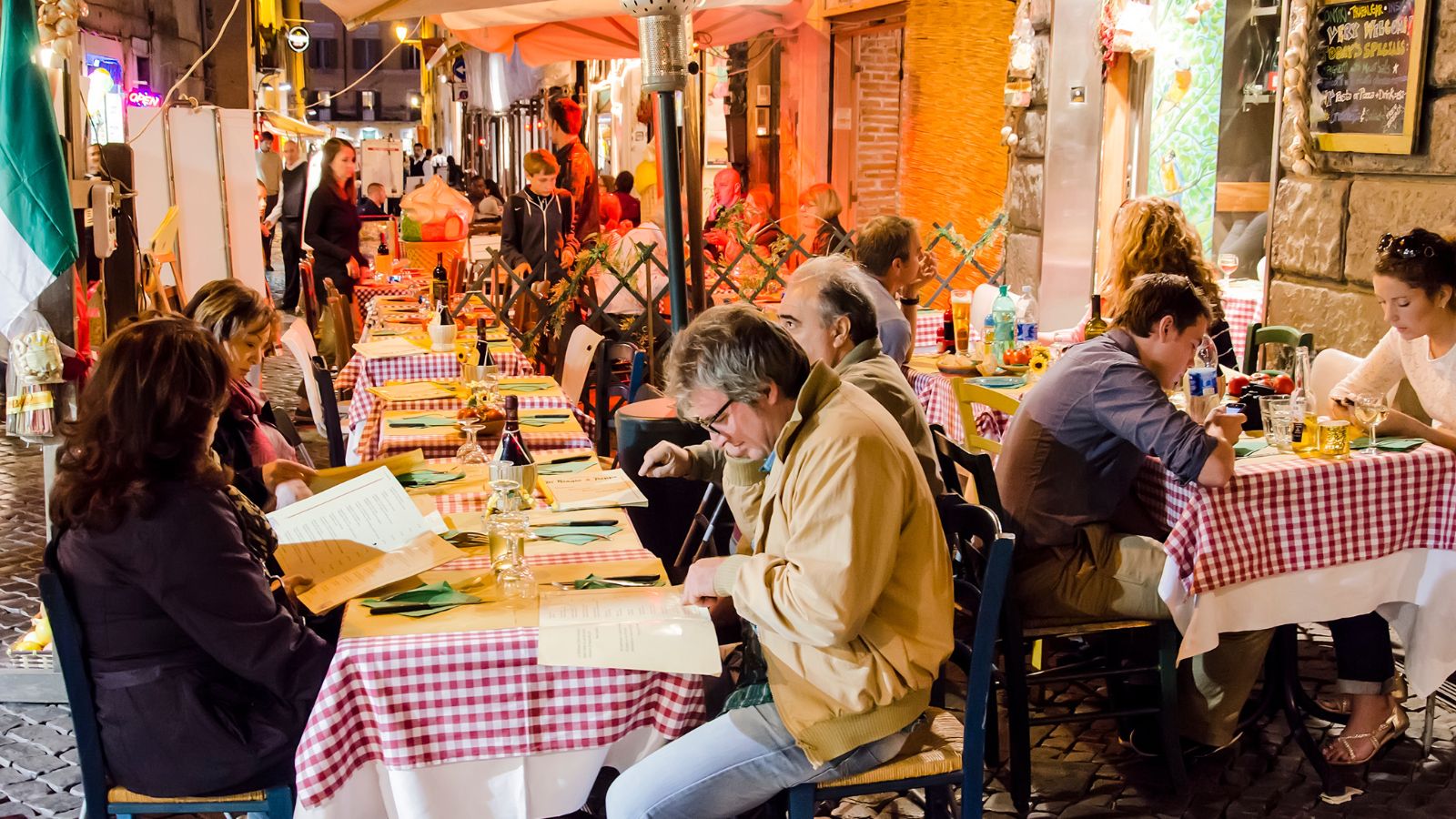 people eating at a restaurant in rome, italy