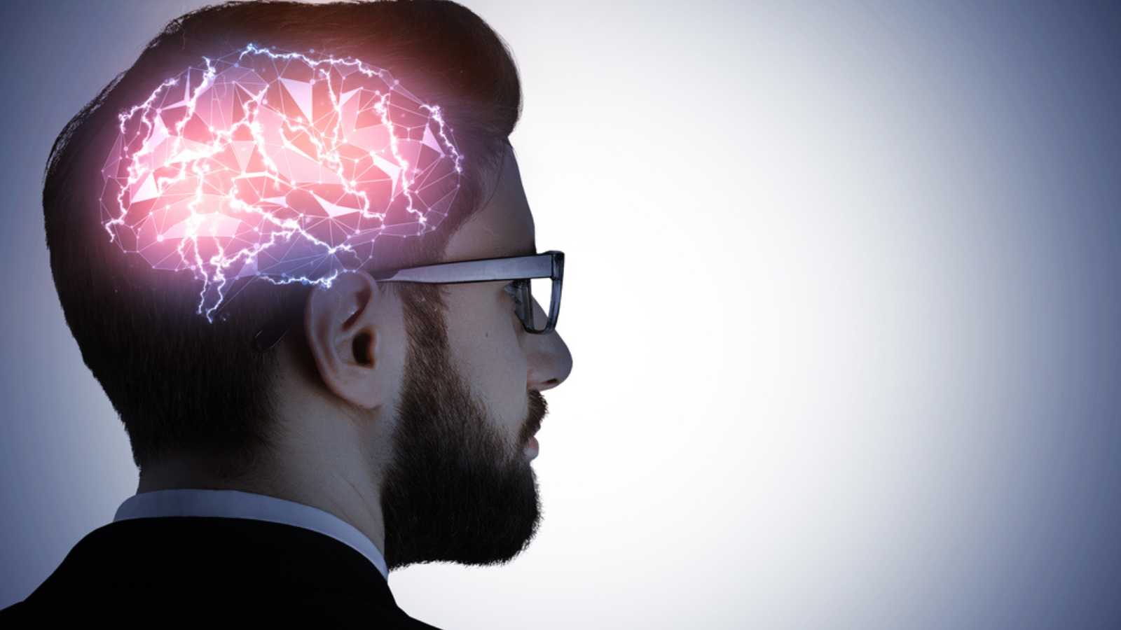 Business-man-in-glasses-with-glowing-digital-brain-