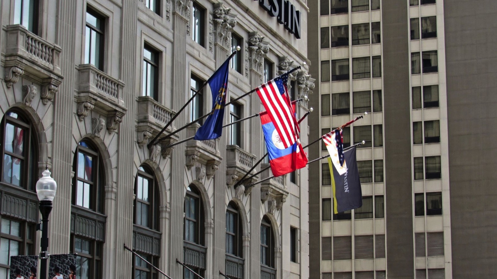 Flags fly over the entrance of the Westin Book Cadillac Hotel on Washington Blvd., downtown