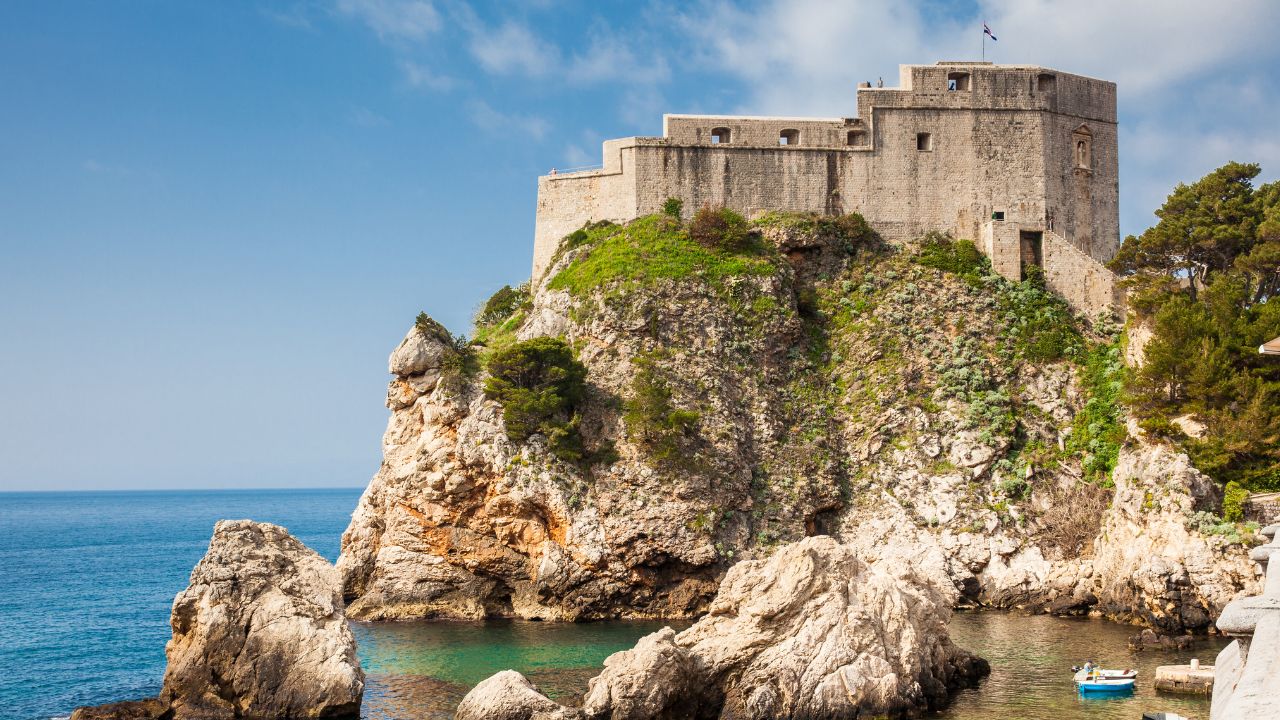 Dubrovnik West Pier and the medieval Fort Lovrijenac located on the western wall of the city