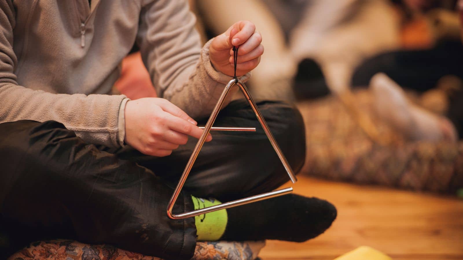 Girl playing a musical triangle