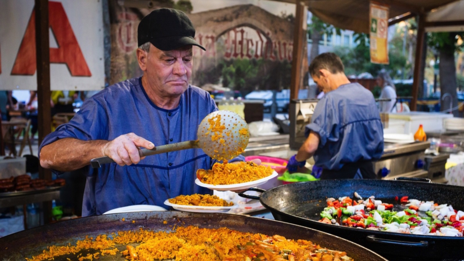 ALICANTE, SPAIN - OCTOBER 14 2023: Spanish traditional food paella, outdoor food market. Rice with shrimps, festival food.