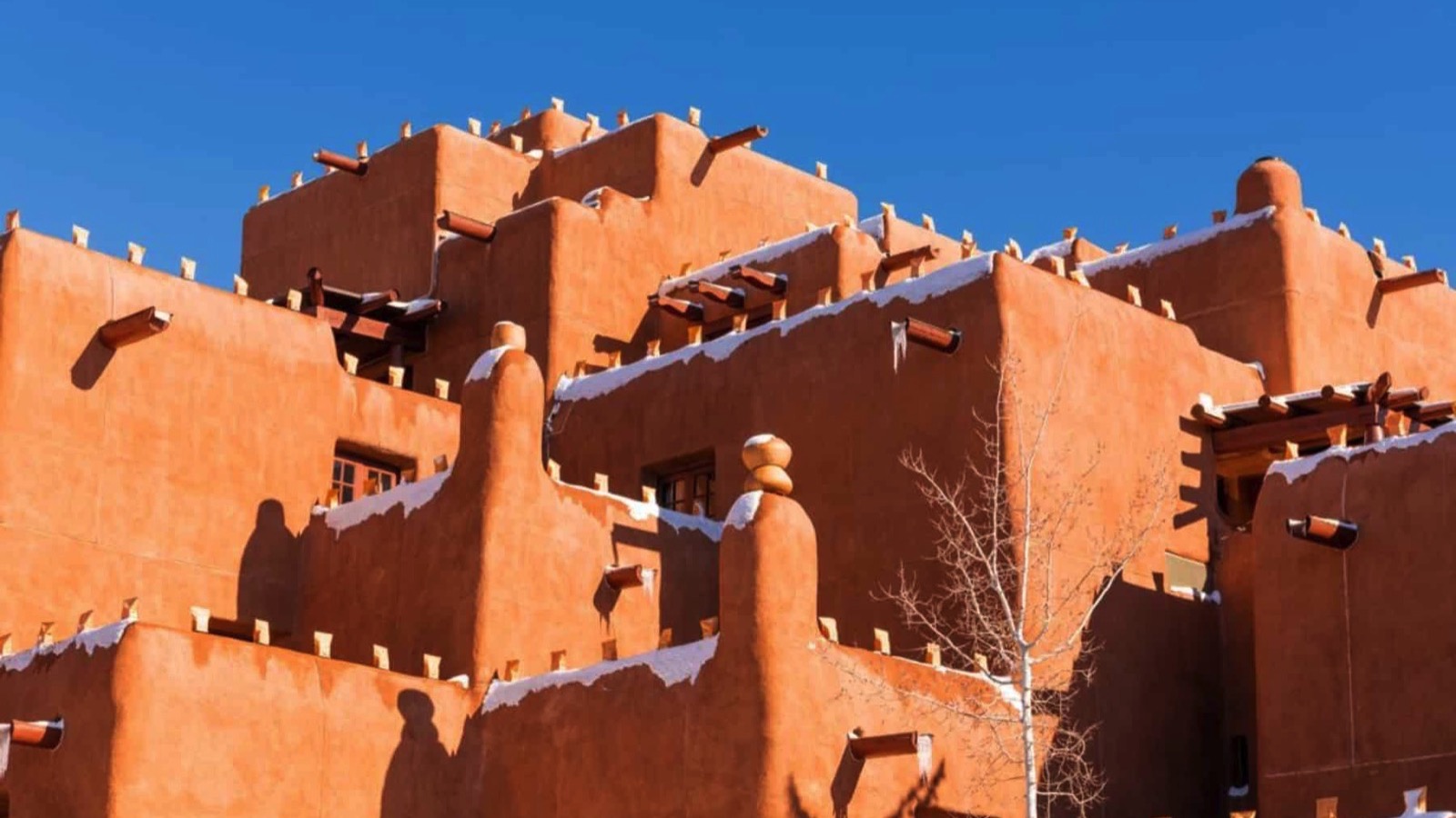 Winter scene of snow-covered adobe pueblo style building in Santa Fe, New Mexico