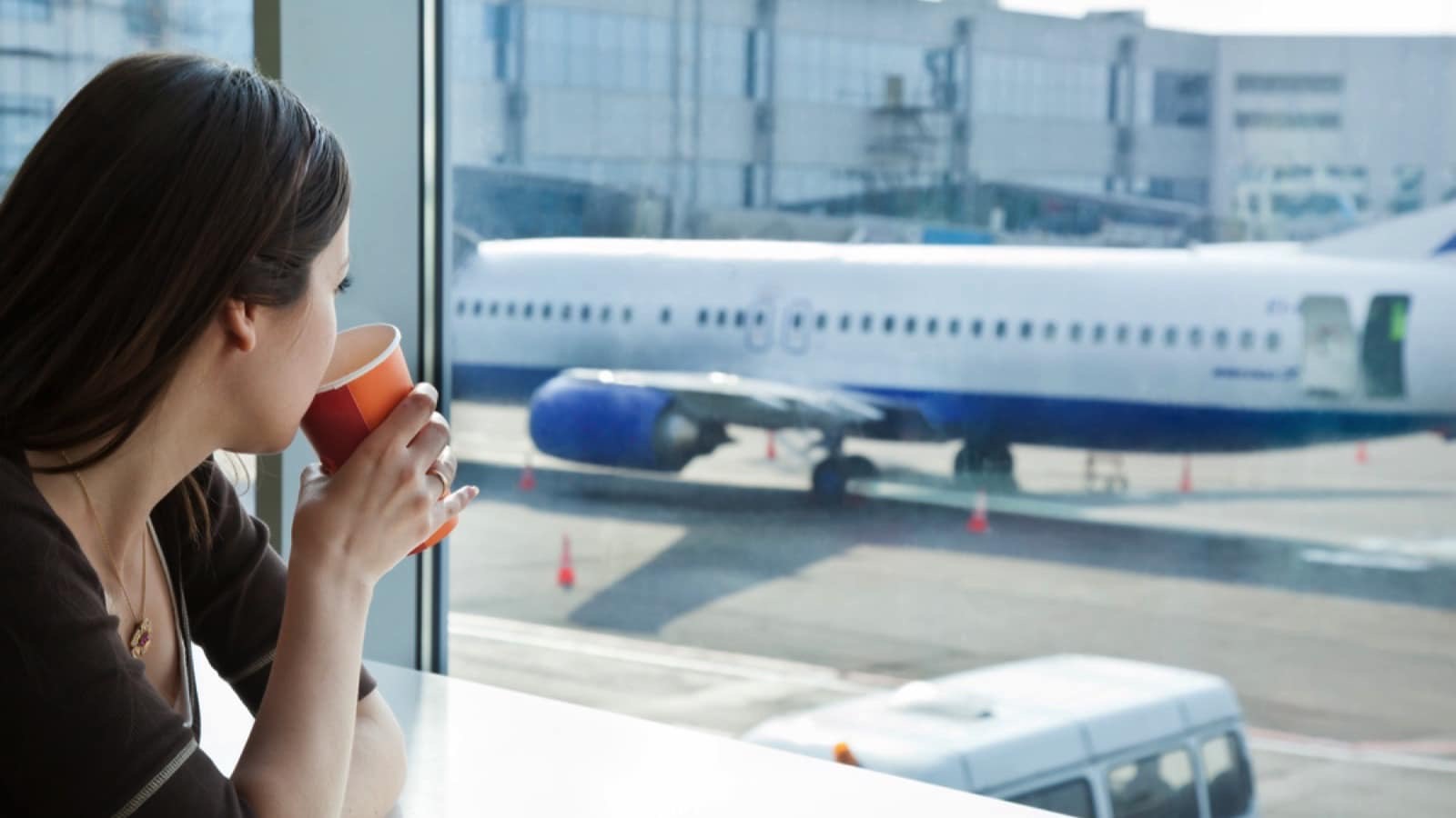 Woman-drinking-tea-and-watcing-airplane