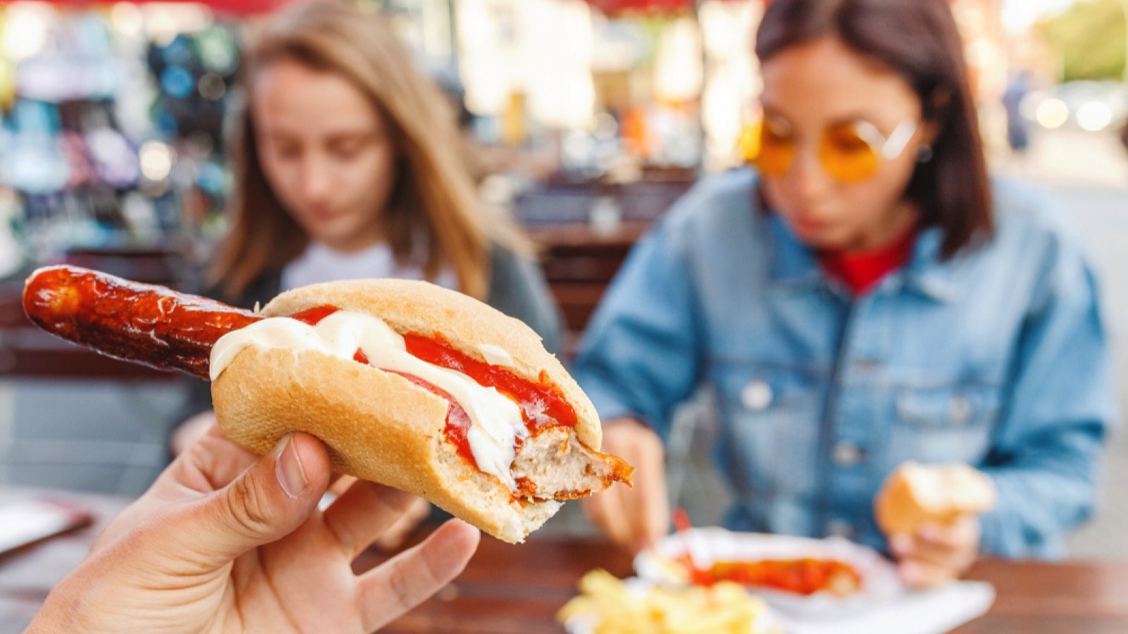 Woman eating Currywurst fast food German sausage