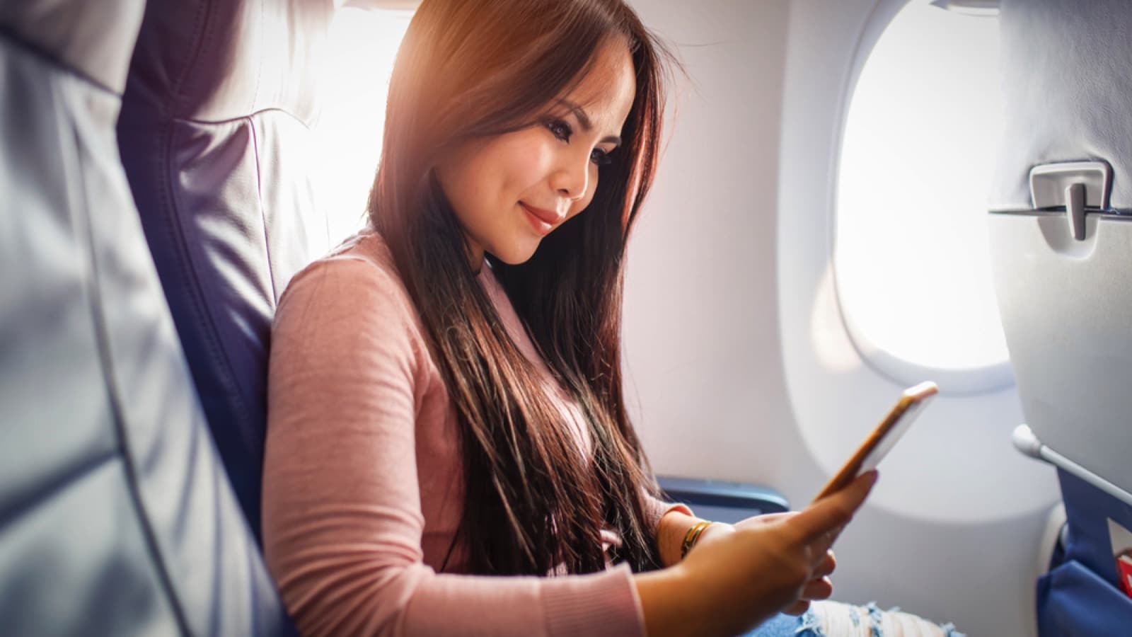 Woman-using-mobile-inside-flight