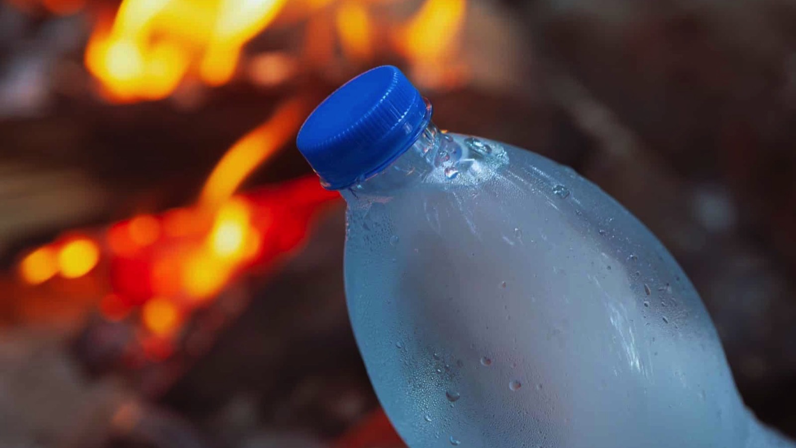 bottle-of-frozen-water-in-front-of-the-fire