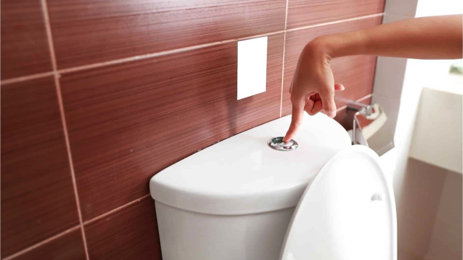 woman-hand-flush-toilet-after-using