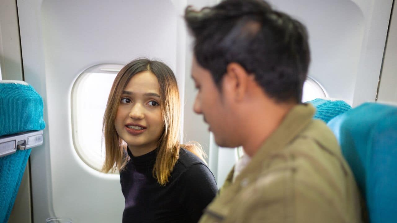 Couple talking in airplane