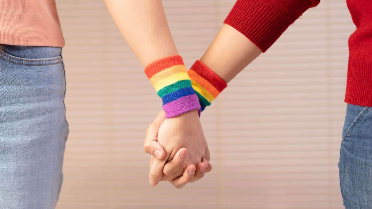 Young women holding hands together