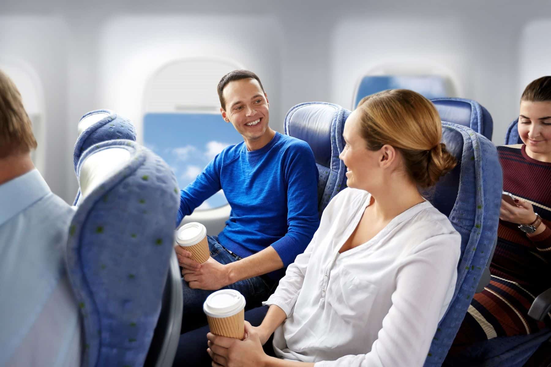 happy-passengers-or-tourists-with-coffee-talking-in-plane