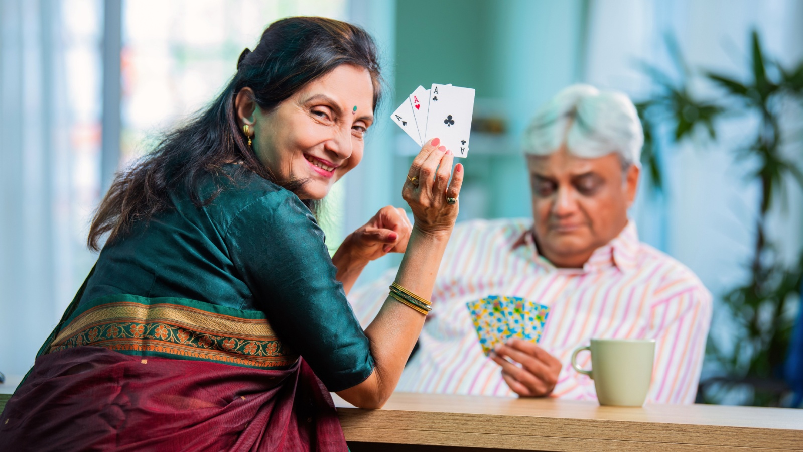 senior mature couple playing cards