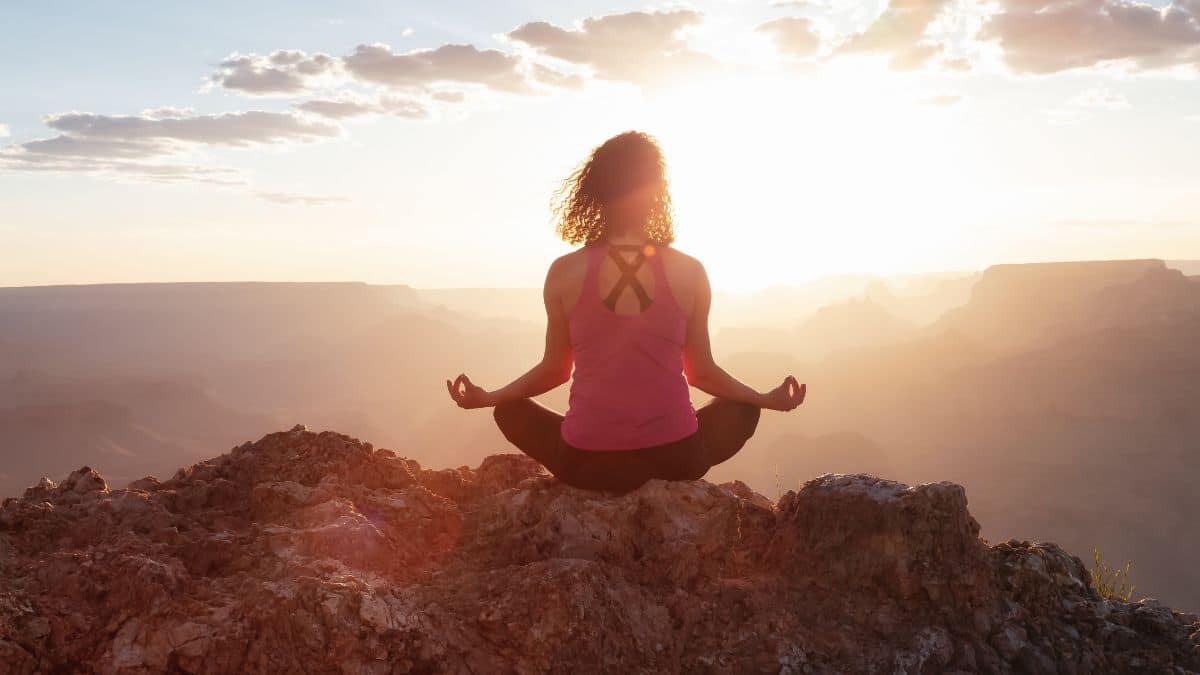 woman-doing-yoga-on-mountain-top