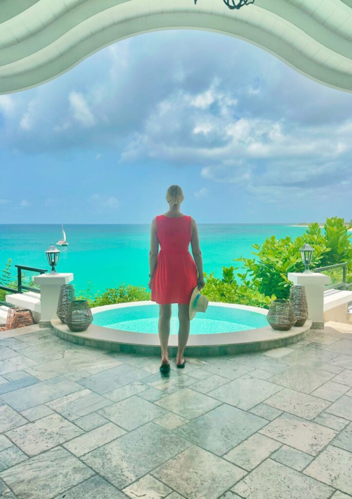 woman in red dress staring out at ocean in st. martin