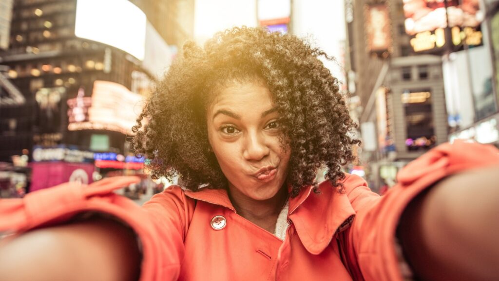 woman taking selfie in New York Time square